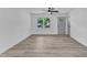The living room showcases wood-look flooring, ample natural light and a light gray door at 460 Bunn Elementary School Rd, Bunn, NC 27508