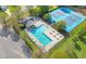 Aerial view showcasing the community pool, tennis court, lounge area, and surrounding landscaping at 479 Manchester Trail, Clayton, NC 27527