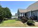 This backyard has a screened-in porch, a patio, and lake views for outdoor enjoyment at 479 Manchester Trail, Clayton, NC 27527