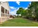 Expansive backyard featuring a covered patio and lush green lawn, ideal for outdoor enjoyment at 479 Manchester Trail, Clayton, NC 27527