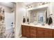 Bathroom featuring double vanity with tile floors and a shower-tub combo at 479 Manchester Trail, Clayton, NC 27527