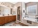 Primary bathroom with double vanity, a soaking tub and separate glass shower at 479 Manchester Trail, Clayton, NC 27527