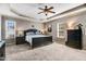 Comfortable bedroom with tray ceiling, dark furniture, and natural light at 479 Manchester Trail, Clayton, NC 27527