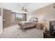Spacious bedroom features neutral carpet, ceiling fan, and large window at 479 Manchester Trail, Clayton, NC 27527