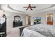 Spacious bedroom with tray ceiling, dark furniture, and carpet flooring at 479 Manchester Trail, Clayton, NC 27527