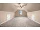 Large bonus room with neutral carpet, vaulted ceilings, and a ceiling fan at 479 Manchester Trail, Clayton, NC 27527