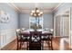 Dining room with hardwood floors and a large window with a vase of plants, creating a warm and inviting atmosphere at 479 Manchester Trail, Clayton, NC 27527