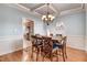 Elegant dining room with decorative trim, chandelier, and hardwood flooring at 479 Manchester Trail, Clayton, NC 27527