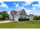 Exterior elevation of a two-story home featuring a two-car garage and landscaped front yard at 479 Manchester Trail, Clayton, NC 27527