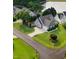 Charming two-story home featuring a manicured lawn, driveway, and attached garage, near a lake at 479 Manchester Trail, Clayton, NC 27527