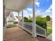 Welcoming front porch with wood flooring, white columns and railings, offering a pleasant outdoor space at 479 Manchester Trail, Clayton, NC 27527