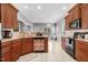 Bright kitchen with granite countertops, stainless steel appliances, and ample storage in the light brown cabinets at 479 Manchester Trail, Clayton, NC 27527