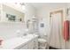 Bright bathroom with a large mirror, white cabinets, and a shower with a curtain at 4808 Berini Dr, Durham, NC 27705