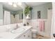 Well-lit bathroom featuring white tiles, a modern sink, and a refreshing atmosphere at 4808 Berini Dr, Durham, NC 27705