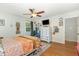 Relaxing bedroom featuring hardwood floors, a ceiling fan, and a window view to the outside at 4808 Berini Dr, Durham, NC 27705