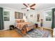 Bright bedroom with a ceiling fan, hardwood floors, and a colorful rug adding warmth at 4808 Berini Dr, Durham, NC 27705