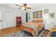 Cozy bedroom features a ceiling fan, hardwood floors, and natural light from the windows at 4808 Berini Dr, Durham, NC 27705