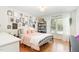 Stylish bedroom with a metal frame bed, gallery wall, and lots of natural light at 4808 Berini Dr, Durham, NC 27705
