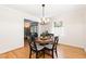 Cozy dining room with a round wooden table, cushioned chairs, and a stylish chandelier at 4808 Berini Dr, Durham, NC 27705