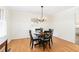 Inviting dining area with round table, cushioned chairs, light fixture and light hardwood flooring at 4808 Berini Dr, Durham, NC 27705