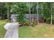 Attractive brick home with a driveway, carport, and lush greenery surrounding the property at 4808 Berini Dr, Durham, NC 27705