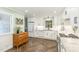 Modern kitchen with white cabinets, granite countertops, stainless steel appliances, and wood-look herringbone floors at 4808 Berini Dr, Durham, NC 27705
