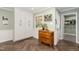 Bright, white kitchen with built-in cabinets, herringbone flooring, and an adjacent doorway at 4808 Berini Dr, Durham, NC 27705