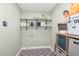 Organized laundry room with shelving, patterned floors, and storage solutions for convenience at 4808 Berini Dr, Durham, NC 27705