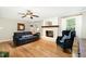 Cozy living room featuring a fireplace, hardwood floors, neutral walls and large windows at 4808 Berini Dr, Durham, NC 27705