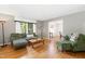 Inviting living room with hardwood floors, neutral walls, and large windows providing natural light at 4808 Berini Dr, Durham, NC 27705