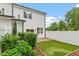 Backyard with a well-maintained lawn, lush landscaping, and a white fence at 520 Kenton Mill Ct, Rolesville, NC 27571