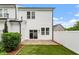 Backyard with artificial turf, white fence and patio at 520 Kenton Mill Ct, Rolesville, NC 27571