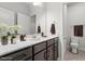 Modern bathroom with gray vanity, white countertop, tile floors, and contemporary fixtures at 520 Kenton Mill Ct, Rolesville, NC 27571
