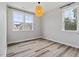 Bedroom with wood floors, neutral walls, and a large window for natural light and neighborhood views at 520 Kenton Mill Ct, Rolesville, NC 27571