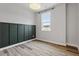 Bedroom featuring wood floors, wainscoting, and a window with natural light at 520 Kenton Mill Ct, Rolesville, NC 27571