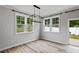 Dining room featuring wood floors, large windows, modern light fixtures, and neutral paint at 520 Kenton Mill Ct, Rolesville, NC 27571
