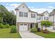 Charming two-story townhome featuring a stone accents, a single-car garage, and a well-manicured lawn at 520 Kenton Mill Ct, Rolesville, NC 27571