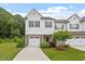 Charming two-story townhome featuring a stone accents, a single-car garage, and a well-manicured lawn at 520 Kenton Mill Ct, Rolesville, NC 27571
