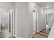 Hallway with wood floors and multiple doorways at 520 Kenton Mill Ct, Rolesville, NC 27571