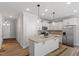 Well-lit kitchen features an island, granite countertops, stainless appliances, and wood look floors at 520 Kenton Mill Ct, Rolesville, NC 27571