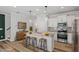 Modern kitchen with stainless steel appliances, center island with seating, and white cabinetry at 520 Kenton Mill Ct, Rolesville, NC 27571