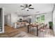 Open-concept kitchen and dining area with modern lighting, stainless steel appliances, and wood flooring at 520 Kenton Mill Ct, Rolesville, NC 27571