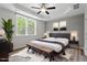 Primary bedroom features tray ceilings, decorative wall, large window and ample natural light at 520 Kenton Mill Ct, Rolesville, NC 27571