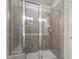 Modern glass enclosed shower with stone colored tiles and dual shower heads at 520 Kenton Mill Ct, Rolesville, NC 27571