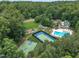 Aerial view of community amenities including a pool, clubhouse, tennis court, basketball court, and playground at 522 N Scotswood Blvd, Hillsborough, NC 27278