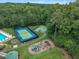 Aerial view of community amenities including a pool, tennis court, basketball court, and playground at 522 N Scotswood Blvd, Hillsborough, NC 27278