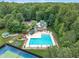 An aerial view of a stunning pool with ample seating and shade, surrounded by lush greenery at 522 N Scotswood Blvd, Hillsborough, NC 27278