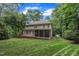 Rear exterior view of a two-story home, complete with a screened porch, and a wooden deck overlooking the lawn at 522 N Scotswood Blvd, Hillsborough, NC 27278
