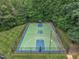 Full aerial view of fenced basketball court surrounded by trees, ready for friendly competition at 522 N Scotswood Blvd, Hillsborough, NC 27278