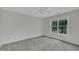Carpeted bedroom with a ceiling fan, fresh paint, and a large window view at 522 N Scotswood Blvd, Hillsborough, NC 27278